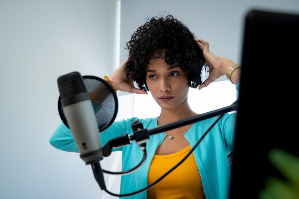 Attractive African American Young Woman Doing Online Podcast With Microphone